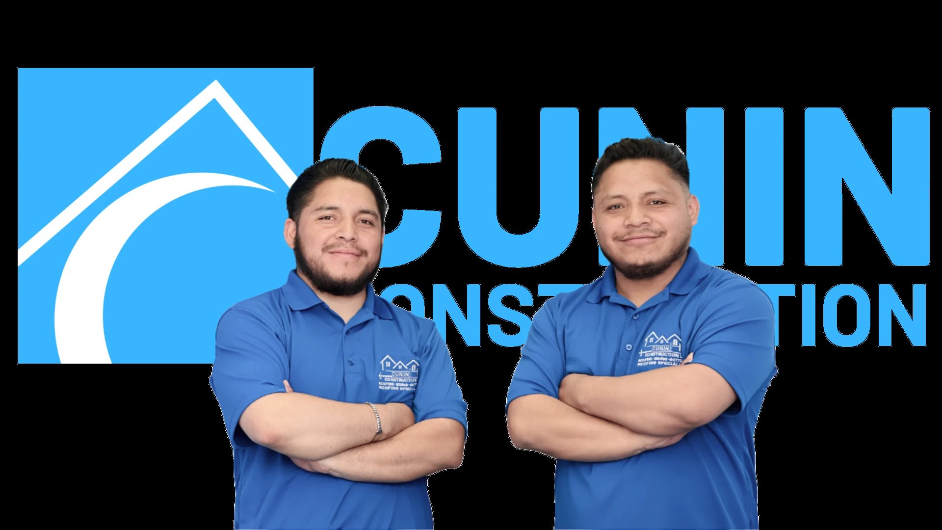 Two men in blue polo shirts standing with arms crossed in front of a blue construction company logo